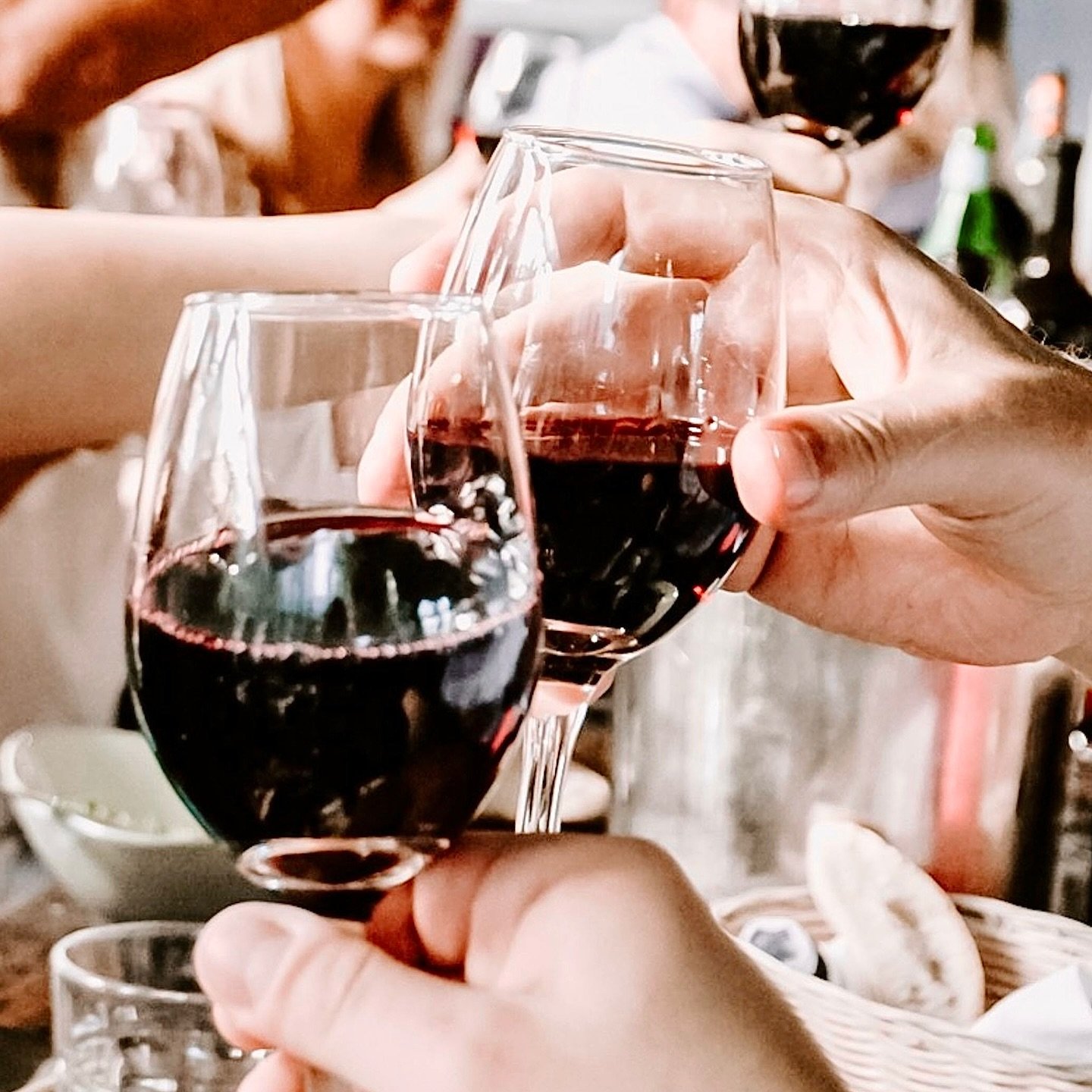 Friends clinking wine glasses in celebration